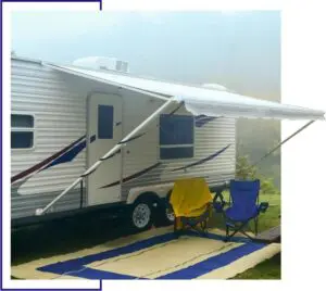 A white trailer with blue and yellow awning